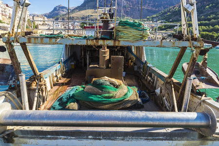 Fishing port with old fishing boats docked at the marina in summer in Castellammare del Golfo in Sicily, Italyの写真素材