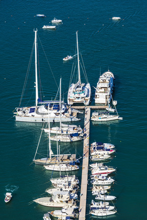 Yachts, boats and sailboats docked at the marina in summer in Castellammare del Golfo in Sicily, Italyの写真素材