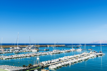 Yachts, boats and sailboats docked at the marina in summer in Castellammare del Golfo in Sicily, Italyの写真素材