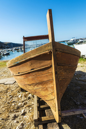 Old wooden fishing boat moored on the beach in summer in Castellammare del Golfo in Sicily, Italyの写真素材
