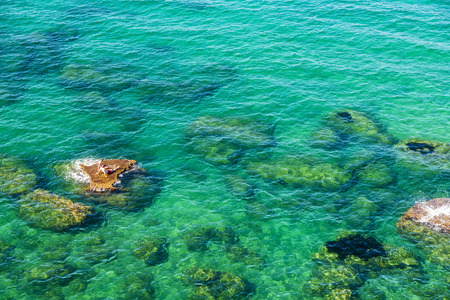 Rocky coast with people bathing in summer in Castellammare del Golfo in Sicily, Italyの写真素材