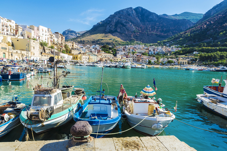 Fishing port with old wooden fishing boats docked at the marina in summer in Castellammare del Golfo in Sicily, Italyのeditorial素材