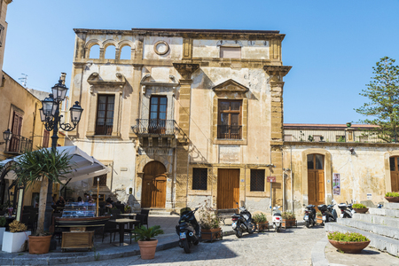 Cefalu, Italy - August 8, 2017: Street of the old town with bar restaurant and people walking of the historic village of Cefalu in Sicily, Italyのeditorial素材