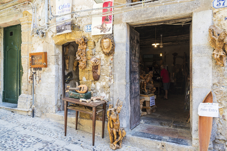 Cefalu, Italy - August 8, 2017: Wooden sculpture shop and workshop in the old town of the historic village of Cefalu in Sicily, Italyのeditorial素材
