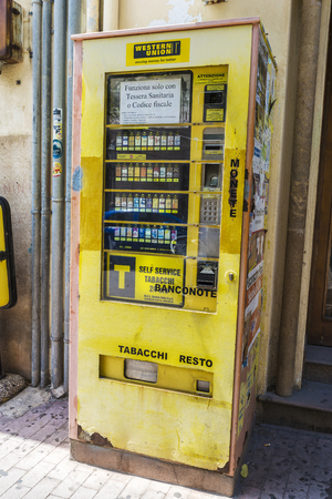 Cefalu, Italy - August 8, 2017: Old vending machine selling tobacco on a street in Cefalu in Sicily, Italyのeditorial素材