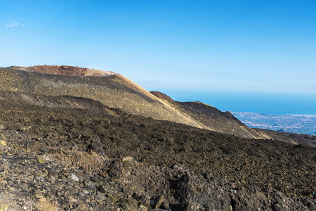 View of Sicily from the Mount Etna with people walking, an active volcano located in Sicily, Italyの写真素材