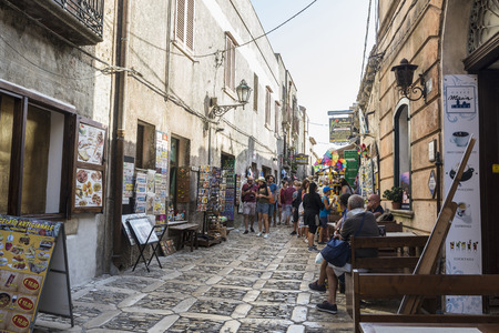 Erice, Italy - August 11, 2017: Street of the old town with shops, bar, restaurants and people around in the historic village of Erice in Sicily, Italyのeditorial素材