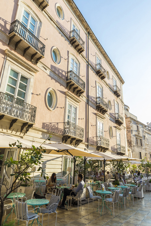 Siracusa, Italy - August 17, 2017: Terrace of a restaurant bar with people around on a street in the old town of the historic city of Siracusa in Sicily, Italyのeditorial素材