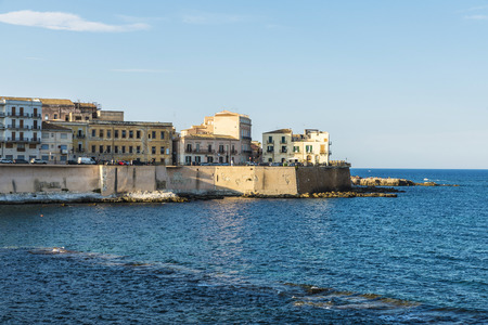 Promenade next to the sea in the old town of the historic city of Siracusa in Sicily, Italyの写真素材