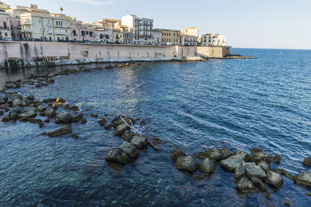 Promenade next to the sea in the old town of the historic city of Siracusa in Sicily, Italyの写真素材