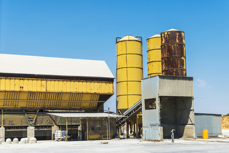 Yellow silos in an abandoned oil refinery in Gela, owned by the oil company Eni, Sicily, Italyの写真素材