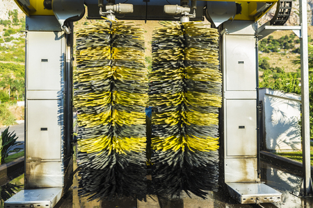 Rotating roller dusters in an automatic washing car at a gas station in Sicily, Italyの写真素材