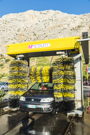 Sicily, Italy - August 19, 2017: Car of the Fiat brand in an automatic washing car at a gas station in Sicily, Italyのeditorial素材