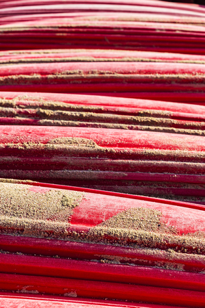 Heap of red kayaks or boats of plastic as abstract backgroundの写真素材
