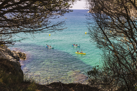 La Fosca beach with people practicing kayaking in Costa Brava, Girona, Catalonia, Spainの写真素材