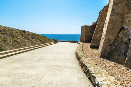 Promenade of La Fosca beach with the Chapel of Sant Esteve (Saint Stephen) in Costa Brava, Girona, Catalonia, Spainの写真素材