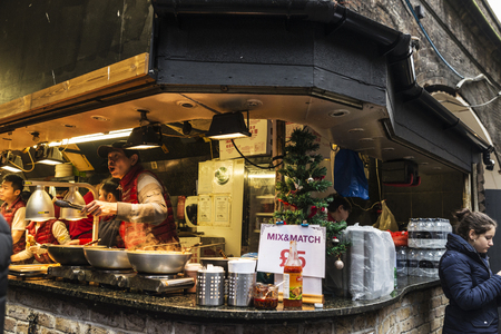 London, England UK  - December 31, 2017: Chefs at a Chinese or Oriental food stand in Camden Lock Market or Camden Town with people around in London, England, United Kingdomのeditorial素材