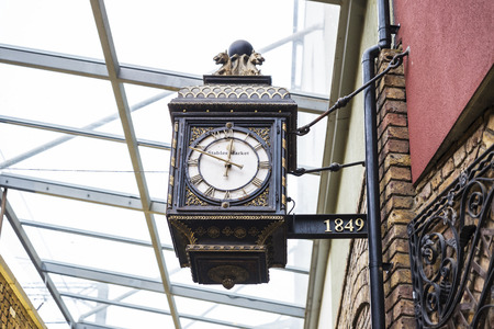 London, England UK  - December 31, 2017: Old classic wooden clock with Roman numerals hanging on the...