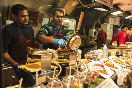 London, England UK  - December 31, 2017: Chefs at a Chinese or Oriental food stand in Camden Lock Market or Camden Town with people around in London, England, United Kingdomのeditorial素材