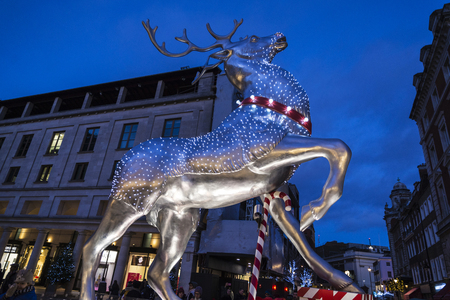 London, United Kingdom - January 1, 2018: Covent Garden, shopping center with stores and restaurants, with a deer decorated with Christmas motifs and people around in London, England, United Kingdomのeditorial素材