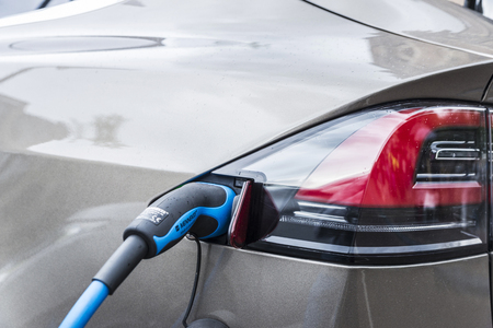 Amsterdam, Holland - September 8, 2018: Electric car Tesla Model X plugged into a power station on a...