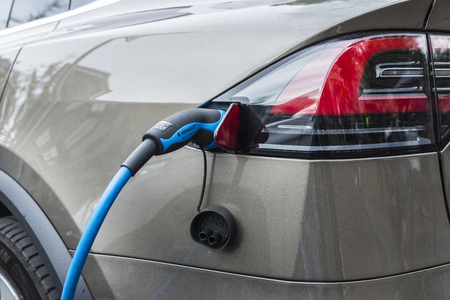 Amsterdam, Holland - September 8, 2018: Electric car Tesla Model X plugged into a power station on a street in Amsterdam, Hollandのeditorial素材