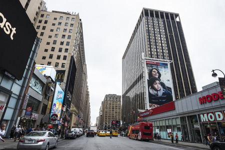 New York City, USA - July 25, 2018: Seventh Avenue with huge advertising screens and people around...