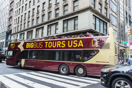 New York City, USA - July 25, 2018: Tour bus parked with people around in Manhattan in New York City, USAのeditorial素材