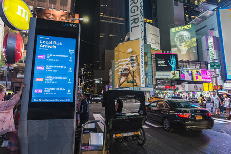 New York City, USA - July 30, 2018: Shops at night on Seventh Avenue (7th Avenue) next to Times Square with people around and large advertising screens in Manhattan in New York City, USAのeditorial素材