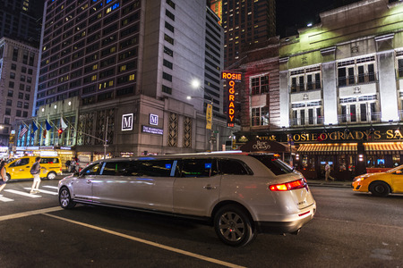 New York City, USA - July 30, 2018: White limousine at night on Seventh Avenue (7th Avenue) next to Times Square with people around in Manhattan in New York City, USAのeditorial素材