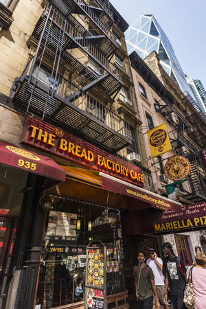 New York City, USA - July 28, 2018: Young people of different races walking in front of the Bread Factory Cafe in 8th Avenue (Eight Avenue), Manhattan, New York City, USAのeditorial素材