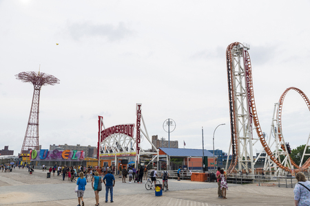 New York City, USA - July 30, 2018: Entrance at the Luna Park amusement park on summer with its attractions like Thunderbolt, Carousell and people walking in Coney Island Beach, Brooklyn, New York City, USAのeditorial素材