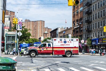 New York City, USA - July 31, 2018: Ambulance car of New York drive along on a street with people...