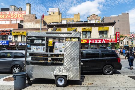 New York City, USA - July 31, 2018: Street food stalls of cookies, shops, farmacy, dentist, grocery...