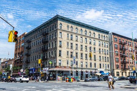 New York City, USA - July 31, 2018: Restaurant and other stores with people around in Harlem,...