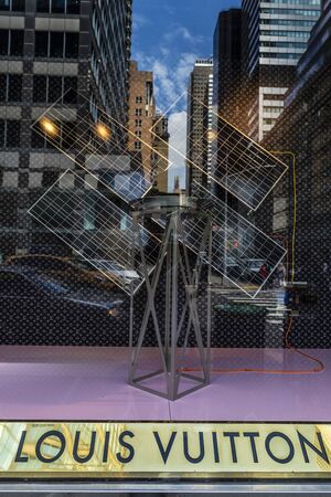 New York City, USA - July 31, 2018: Display of Louis Vuitton, luxury clothing shop, with reflections...