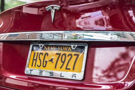 New York City, USA - August 3, 2018: Closeup of a red electric car Tesla parked on a street in New York City, USAのeditorial素材