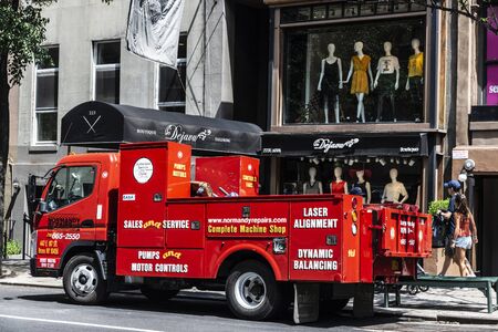 New York City, USA - July 31, 2018: Red truck of a pump motors repair company on a street with people around in Manhattan, New York City, USAのeditorial素材