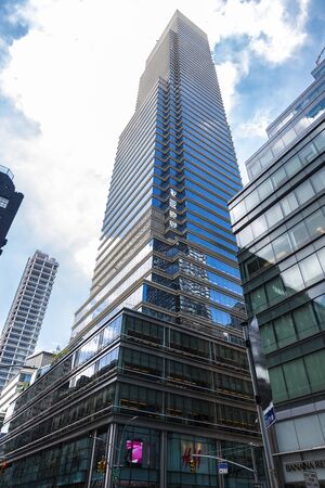 New York City, USA - July 31, 2018: Low-angle shot of modern glass skyscrapers and a H&M store in...