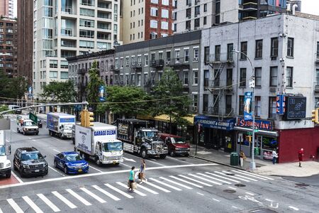 New York City, USA - July 31, 2018: Overview of a street with its skyscrapers, traffic and people...