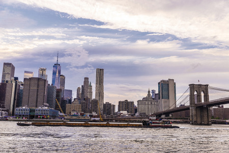 Skyline of the Brooklyn Bridge and modern skyscrapers of New York Financial District and the Lower...
