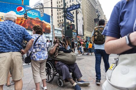 New York City, USA - July 31, 2018: Poor black man in a wheelchair on a street in Manhattan, New York City, USAのeditorial素材