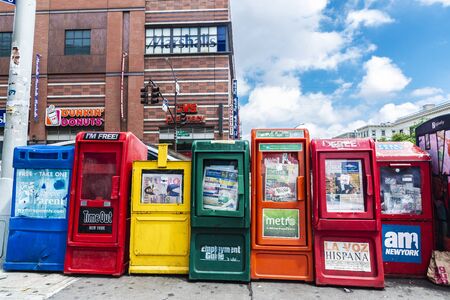 New York City, USA - August 1, 2018: Automatic machine vending of newspapers like Metro, Timeout, AM, La voz hispana on a street in Manhattan, New York City, USAのeditorial素材