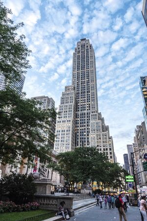 New York City, USA - August 1, 2018: Street with people walking and skyscrapers in Manhattan, New...