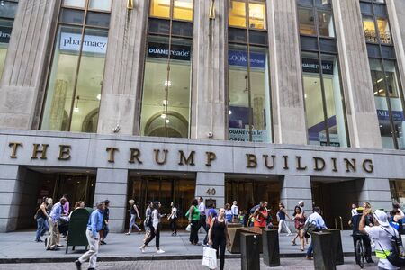 New York City, USA - August 1, 2018: Facade of The Trump Building on 40 Wall Street with people...