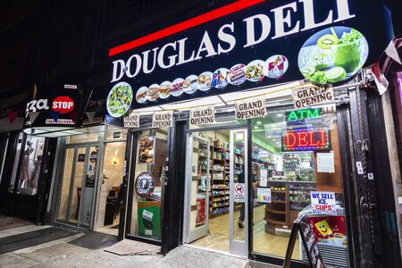 New York City, USA - August 1, 2018: Display of a Deli and grocery at night in Harlem, Manhattan,...