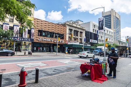 New York City, USA - August 1, 2018: Vendor in his clothes stall on a street in Harlem, New York City, USAのeditorial素材