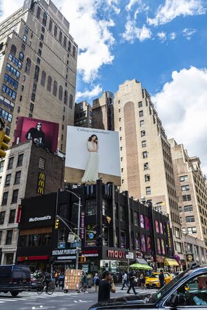 New York City, USA - August 2, 2018: People and traffic on a street in Manhattan, New York City, USA
