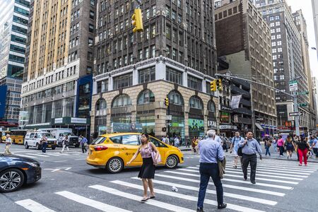 New York City, USA - August 2, 2018: People going through a pedestrian crossing in Manhattan, New York City, USAのeditorial素材