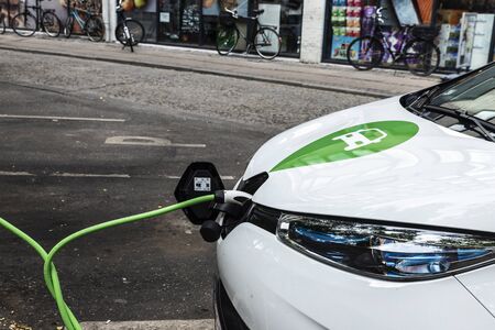 Copenhagen, Denmark - August 27, 2019: Electric car recharging batteries at a recharge point on a...